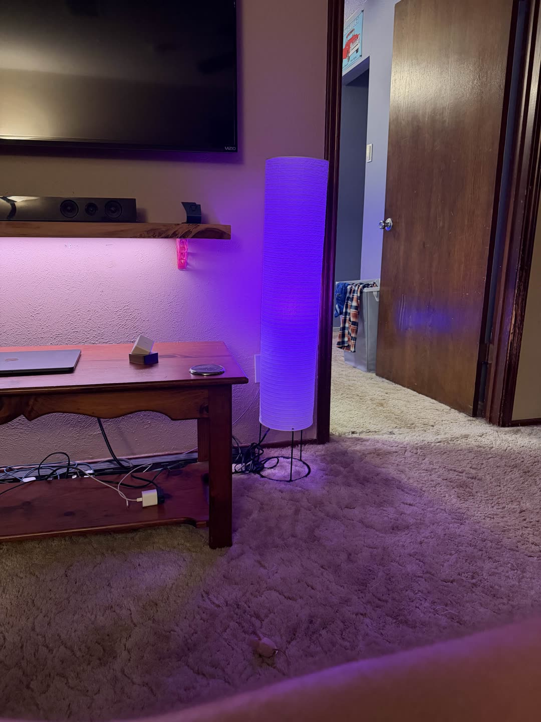 An IKEA KAJPLATS bulb glowing purple in Brandon's house